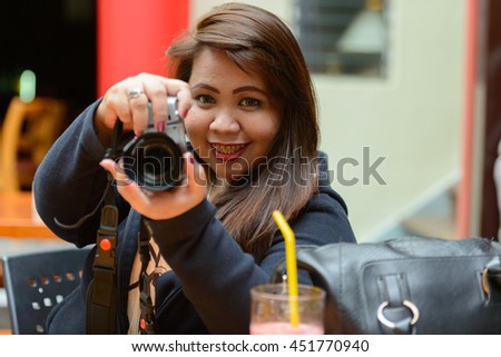 Fat woman photographing
