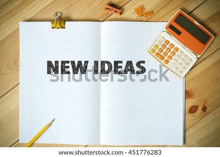 NEW IDEAS text on paper in the office , business concept