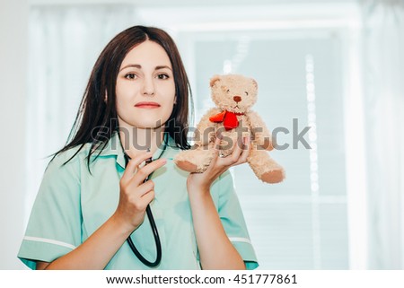 Portrait of woman doctor at hospital with teddy