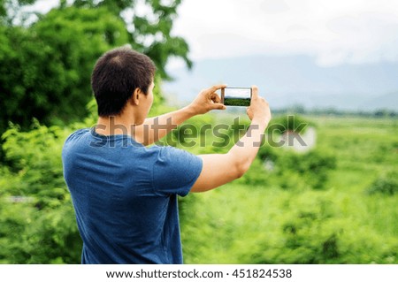 Man take a landscape photo.