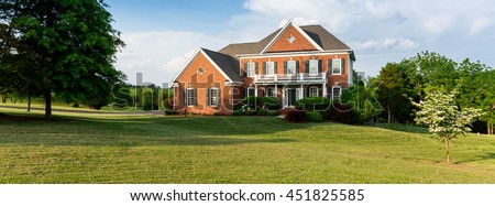 Front of home and garage of large single family modern US house ideal for social media page of realtor. Sized to fit a cover photo placeholder