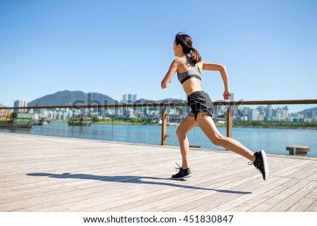 Asian Woman running in city of Hong Kong