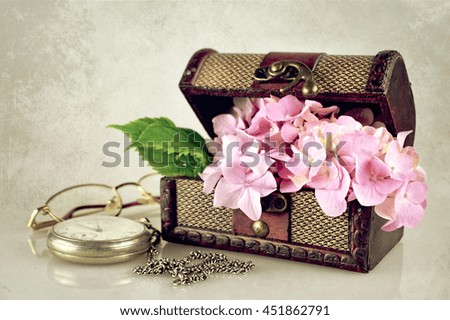 Flowers in the treasure chest on grunge background