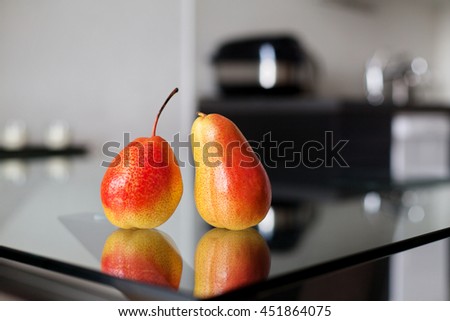 Still life - two pears on the glass table