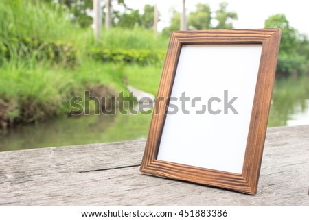 blank wooden picture frame on backdrop nature and the floor
