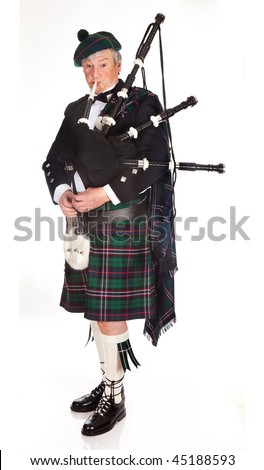 Scottish highlander wearing kilt and playing bagpipes Royalty-Free Stock Photo #45188593