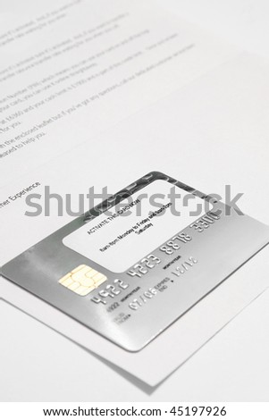 new bank card still attached to bank letter with activate sticker still on card