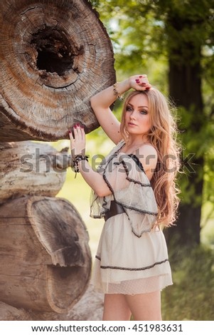 Beautiful bohemian blonde girl in spring garden