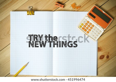 TRY THE NEW THINGS text on paper in the office , business concept