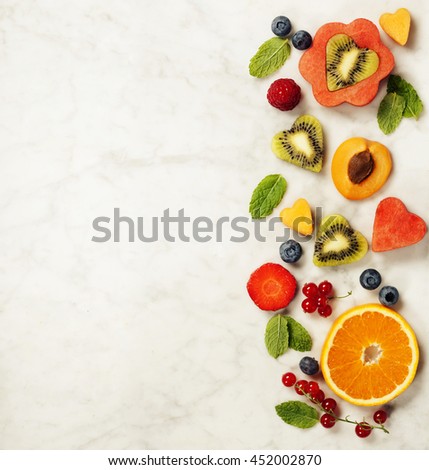 Various berries and fruits on white marble background. Healthy food concept. Flat lay