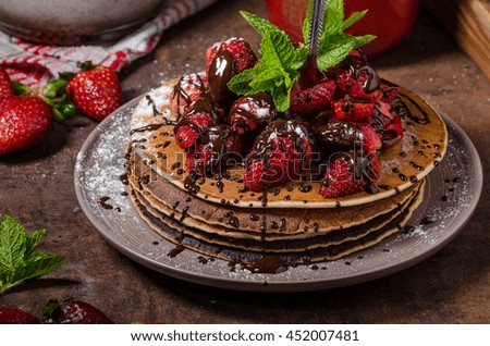 American pancakes with fresh strawberries and chocolate, fresh mint herb