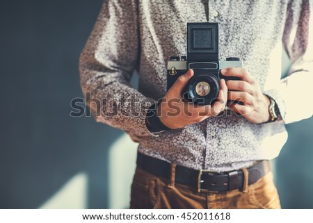 old medium format camera in photographer hands in studio