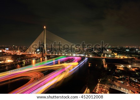 The colorful night cityscape of Rama 8 Bridge, the important famous landmark in Bangkok, Thailand. 
