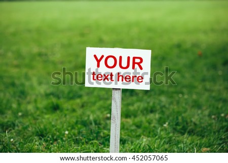 your text here sign against green lawn background