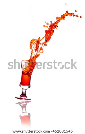Drink red Splash out of glass on a white background.