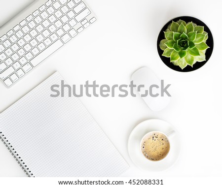 White office desk table with wireless aluminum keyboard, paper, cup of coffee and succulent flower in pot. Top view with copy space. Flat lay.  Royalty-Free Stock Photo #452088331