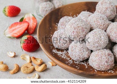 Homemade strawberry, date, cashew and coconut bliss ball, keto, ketogenic, low carb diet dessert Royalty-Free Stock Photo #452114209