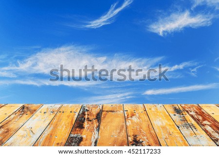 Wood floor top on blue sky background, Cloudy blue sky and wood berth, used for display your products.