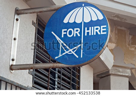 Sign advertising beach chairs and umbrellas for hire