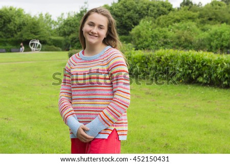 Long-haired teenage girl in summer park
