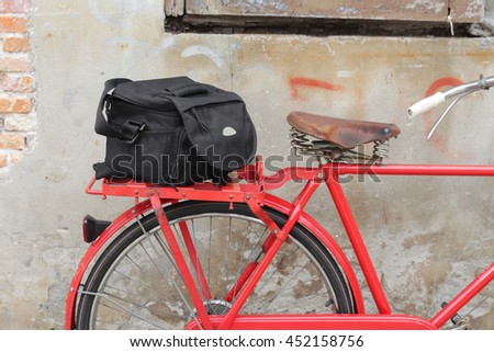 Bag Black bicycle travel saddle Closeup, old brick wall background