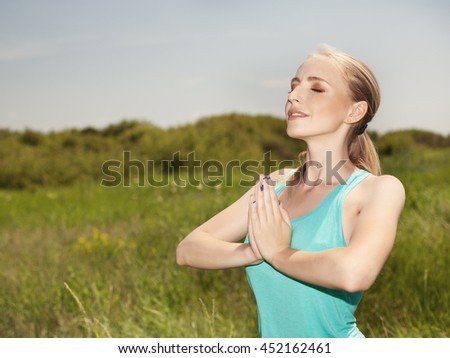 Beautiful  young  woman exercising in the outdoors yoga photo on nature