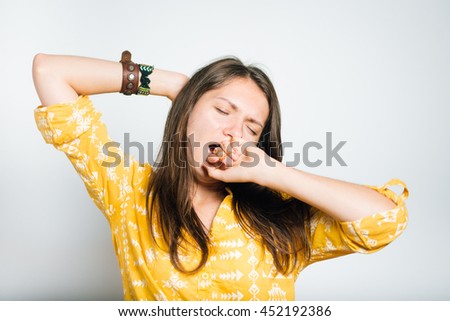 pretty girl having fun yawning, studio photo, isolated
