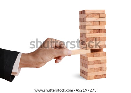 Business man hand pick and put last piece block of the wood puzzle, abstract business concept of last important solution in strategy.  Royalty-Free Stock Photo #452197273