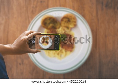 Adult man taking a picture with smartphone. Food shot.vintage color
