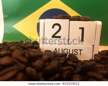 August 21st. Image of august 21 wooden white color calendar on Brazil flag and coffee beans background. Summer day. 