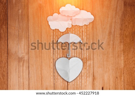 paper heart shape umbrella and rain on wooden texture floor
