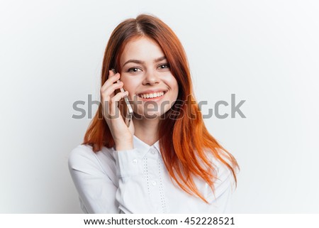 girl in a white blouse with a telephone , isolated