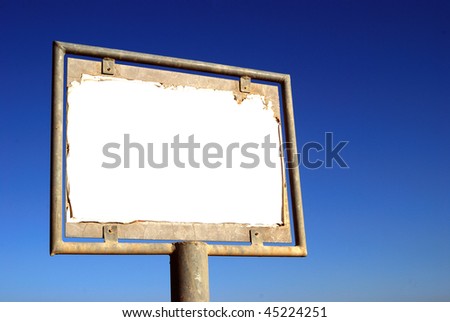 Old rusty blank billboard on sky background