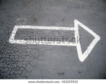 on asphalt painted arrow