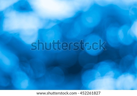 Blue blurred nature backdrop with color and bright sun light. Bokeh background or Christmas on summer holidays and concept.