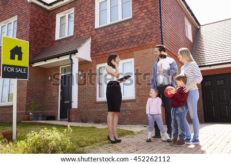 Realtor Outside House For Sale With Young Family
