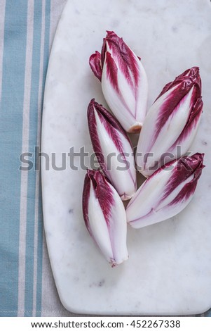 red crunchy chicory on marble board
