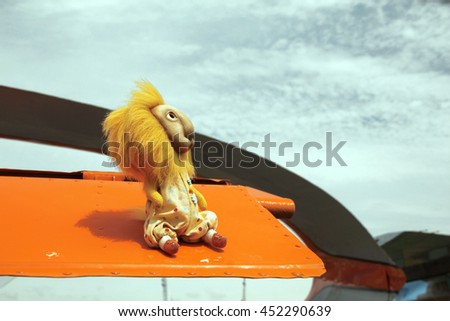 Photo portrait of funny teddy toy character lion in the aircraft environment, devices and equipment. Suitable for print advertising, book cover or a notebook.