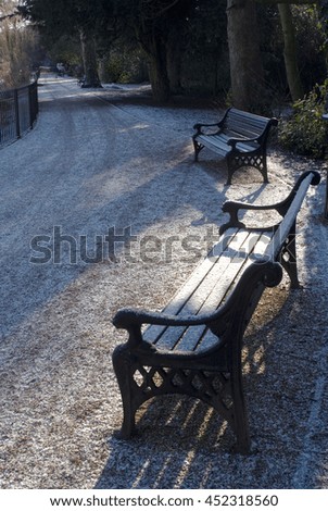 Park bench under a light dusting of snow