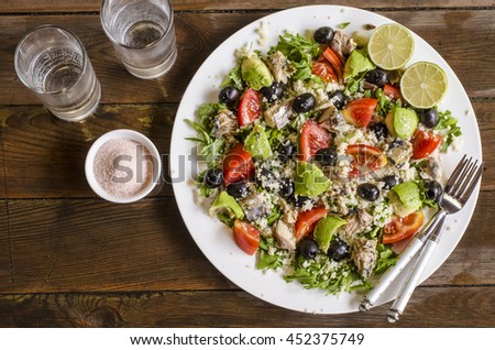 Couscous salad with tomatoes and arugula fish olives avocados    