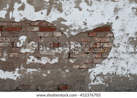 Old brick wall with cracked plaster