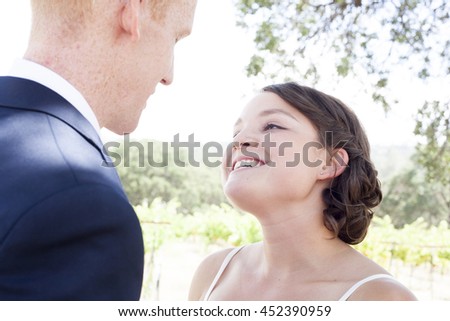 A couple on their wedding day looking at each other