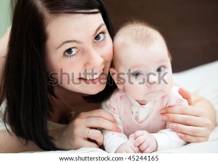 Adorable baby and mother in home