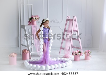 The girl in the purple dress with large beads