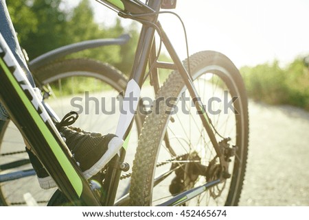 Bike standing on the road and it keeps foot girl