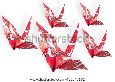 Red origami bird on white background