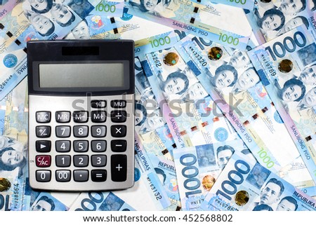 Success and got profit from business with colorful of Philippines peso money,currency banknotes and calculator ready for exchange
