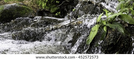 Small rocky waterfall flowing.