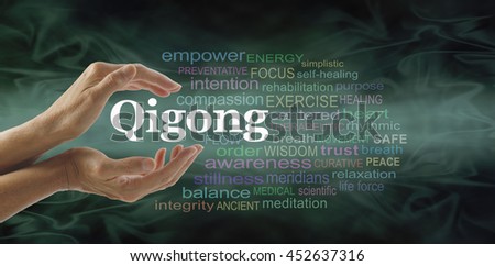 Qigong word cloud and healing hands - female cupped hands with the word QIGONG between surrounded by word cloud on a flowing green light and dark background Royalty-Free Stock Photo #452637316