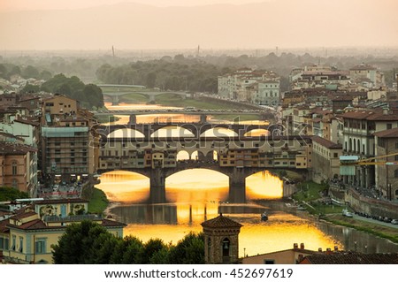 Arno river and famous Ponte Vecchio enlighten by the warm sunlight. Florence, Italy.
